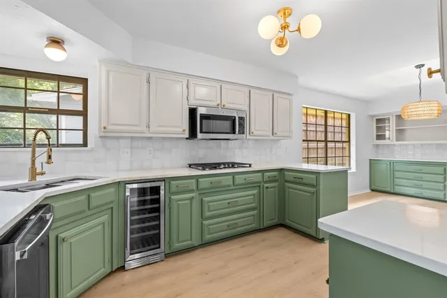 a kitchen with cabinets a window and a sink