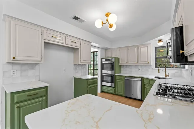 a kitchen with a sink appliances and cabinets