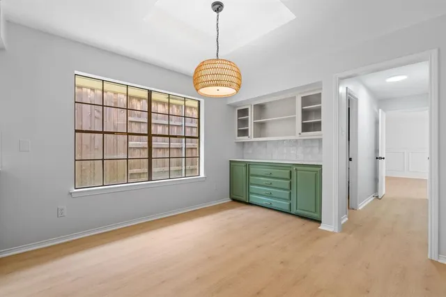 a room with window and chandelier fan