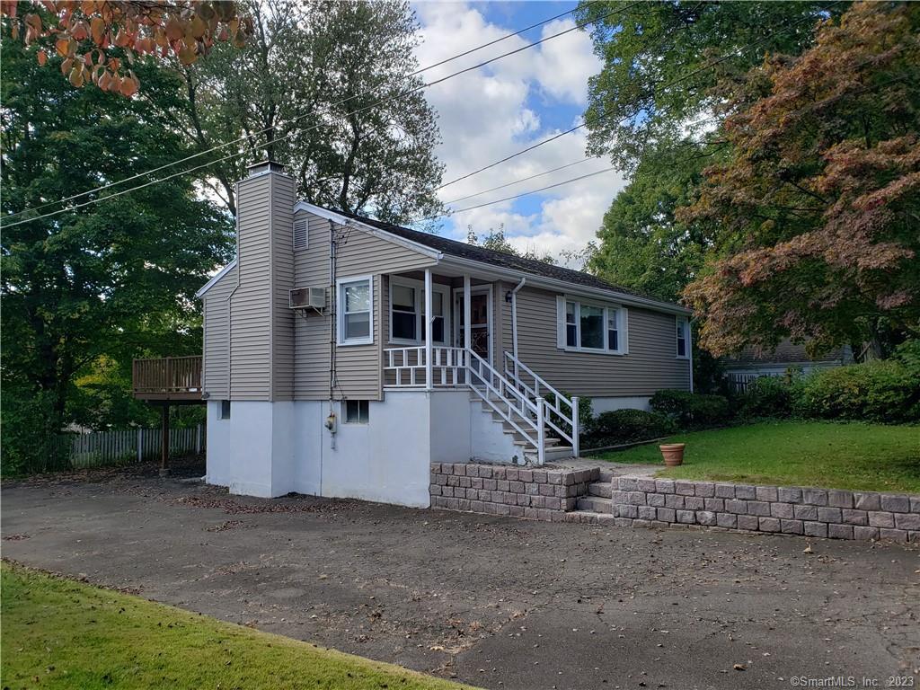a view of a house with backyard and trees