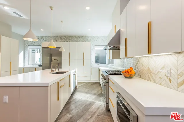 a kitchen with a sink a stove and cabinets