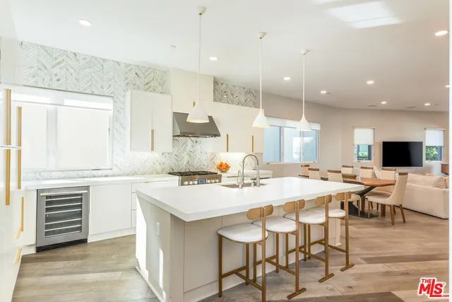 a large kitchen with a table and chairs