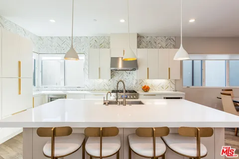 a kitchen with a table chairs stove and microwave