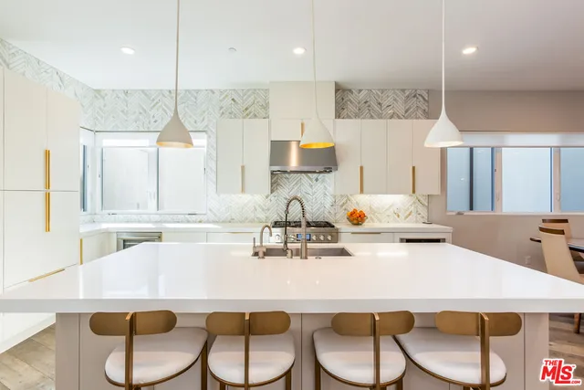 a kitchen with a table chairs stove and microwave