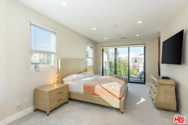 a bedroom with a bed and a couch