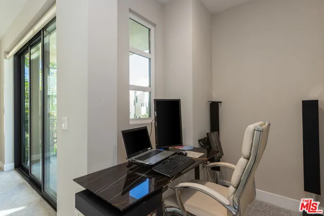a view of a balcony with chair and tables