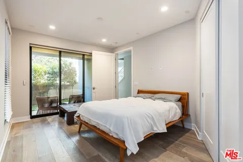 a bathroom with a sink a toilet a mirror and shower