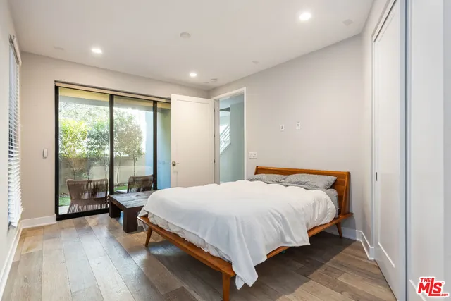 a bathroom with a sink a toilet a mirror and shower