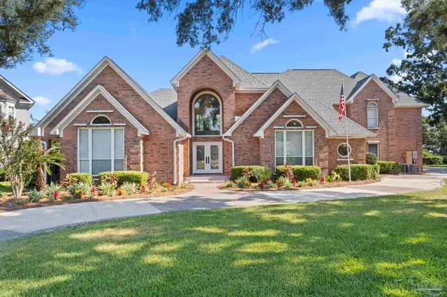 an aerial view of a house with a swimming pool patio and outdoor seating