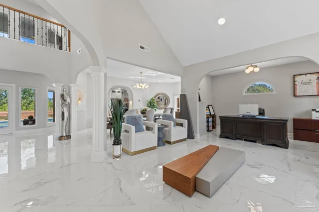 a dining room with furniture a chandelier and a rug