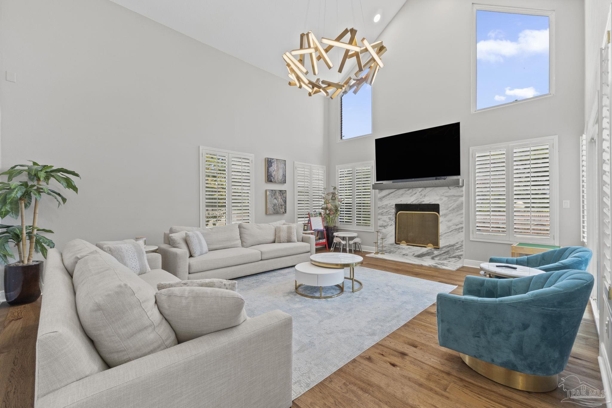 4818 Rosemont Place Pensacola, FL 32514 - Photo 14 of 69 a living room with furniture a fireplace and a flat screen tv