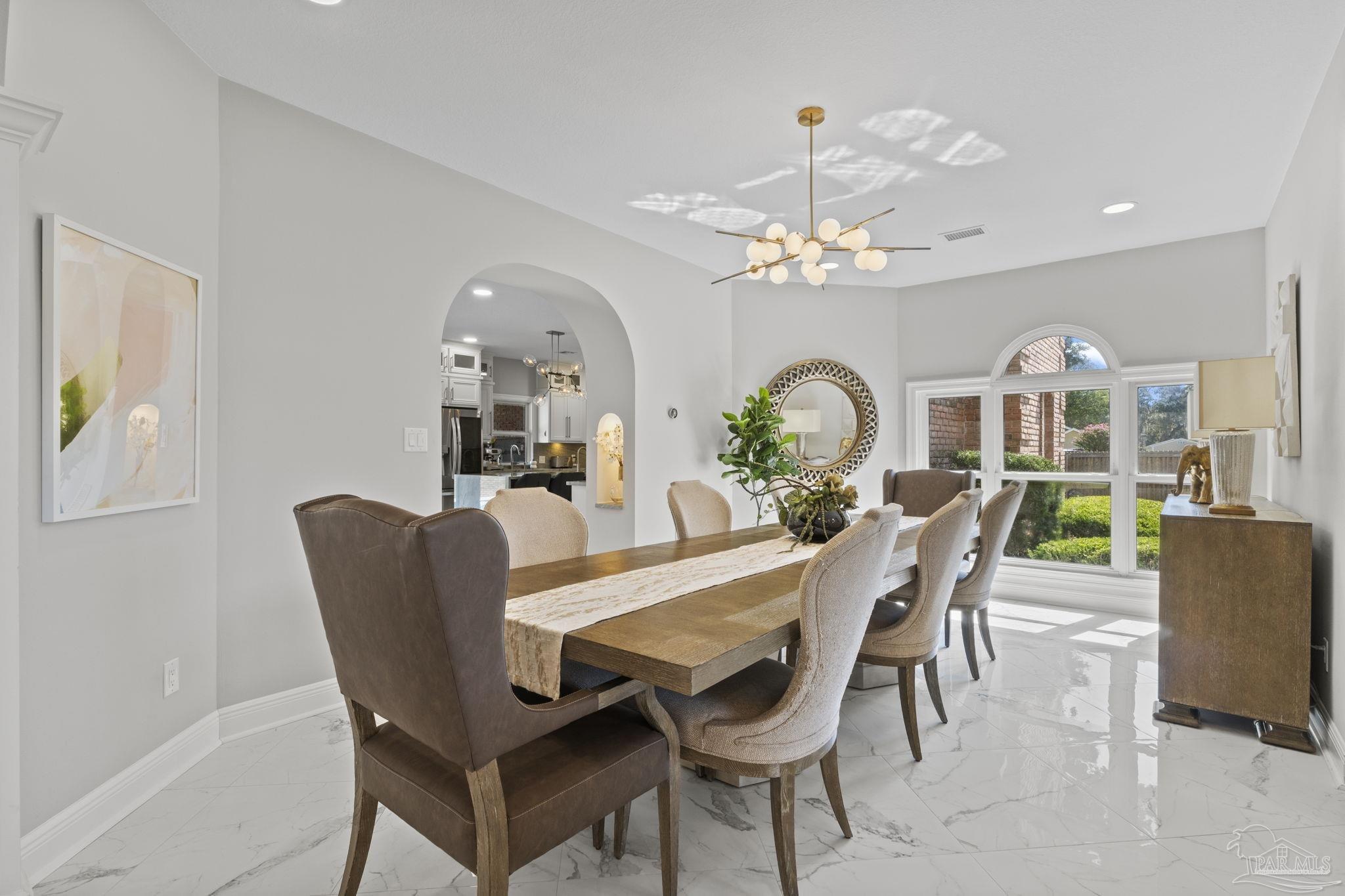 4818 Rosemont Place Pensacola, FL 32514 - Photo 17 of 69 a dining room with furniture a chandelier and a rug