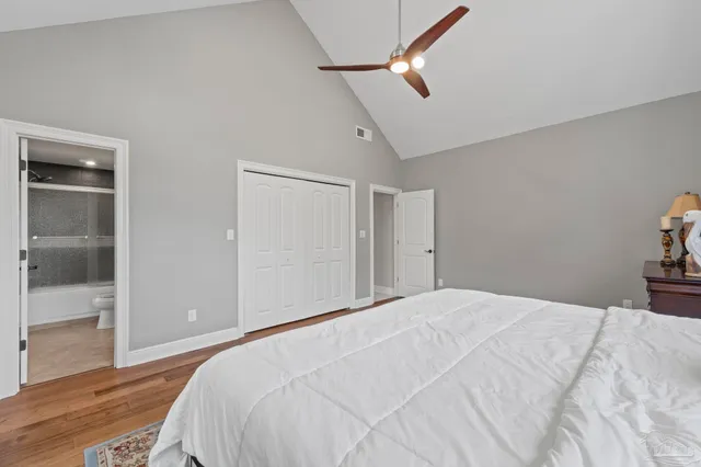 a bedroom with bed tv and window