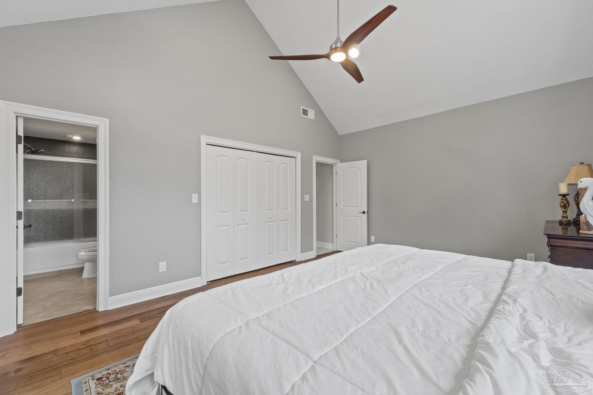 4818 Rosemont Place Pensacola, FL 32514 - Photo 29 of 69 a bedroom with a large bed and wooden floor