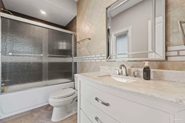a spacious bathroom with a large tub sink and mirror