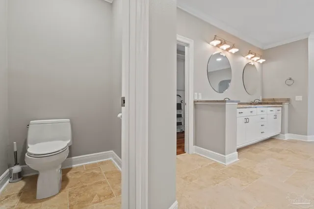 an aerial view of a house with outdoor space and trees all around