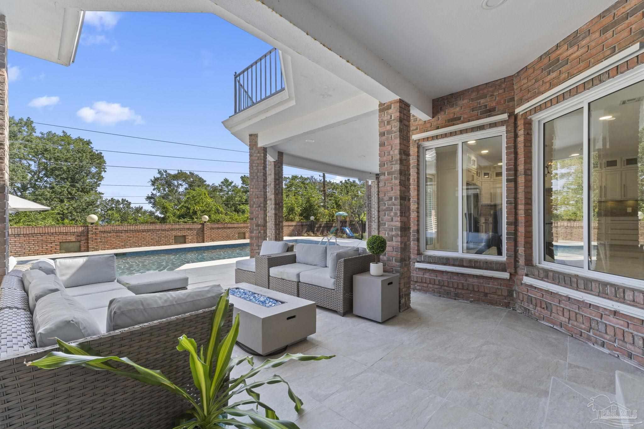 4818 Rosemont Place Pensacola, FL 32514 - Photo 50 of 69 a living room with patio furniture and garden view