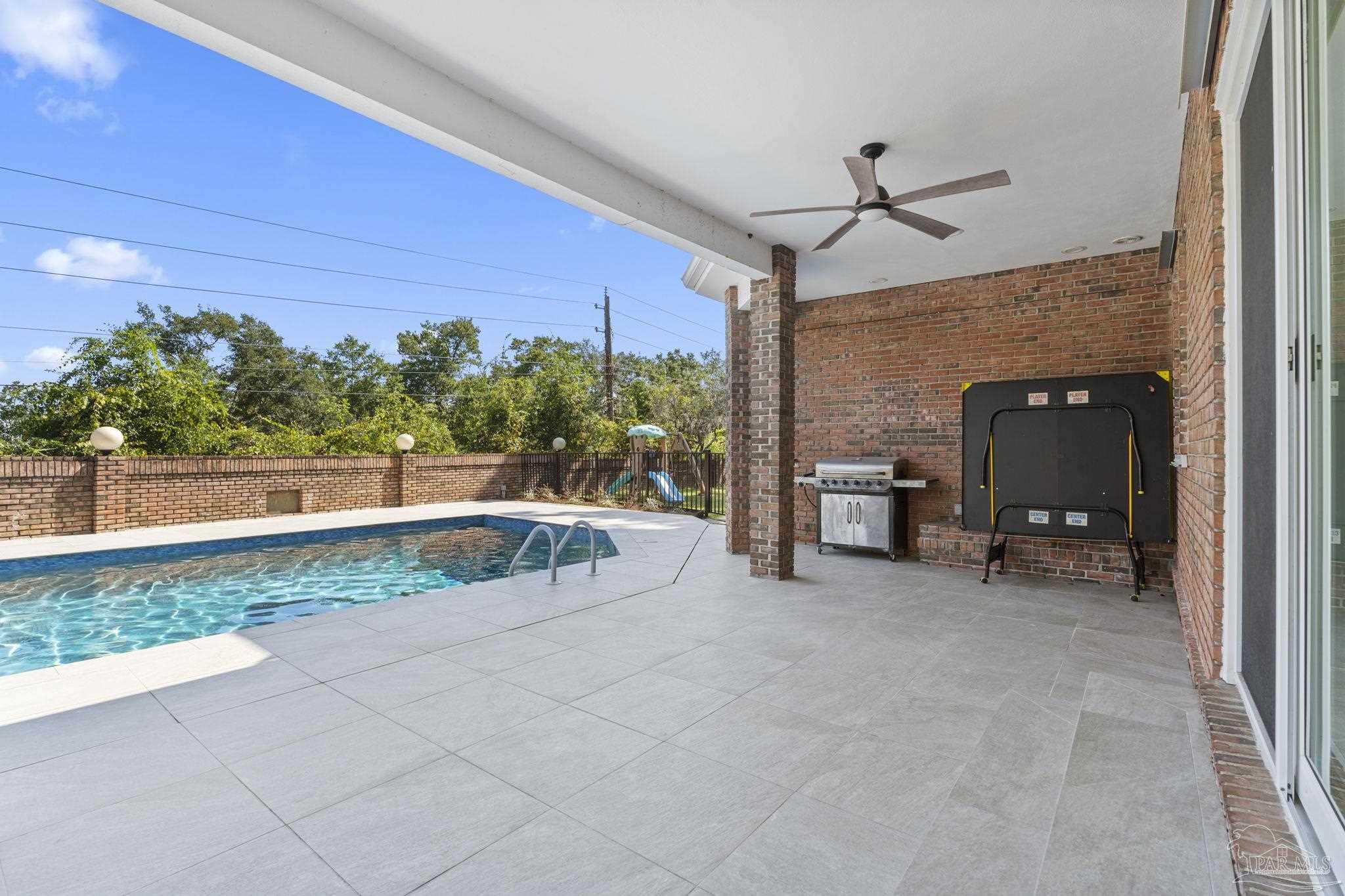 4818 Rosemont Place Pensacola, FL 32514 - Photo 52 of 69 a view of a patio with a table and chairs under an umbrella