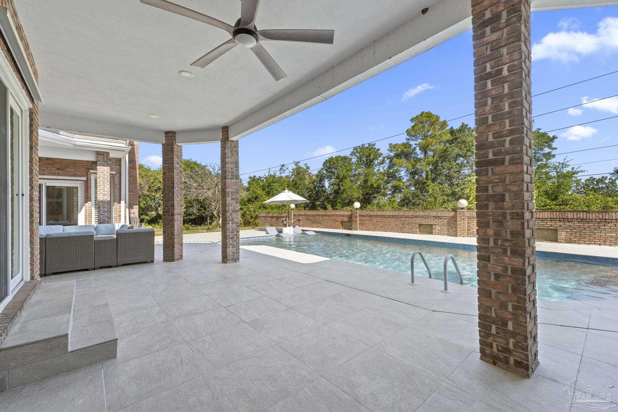 4818 Rosemont Place Pensacola, FL 32514 - Photo 54 of 69 a view of a patio with a table and chairs under an umbrella