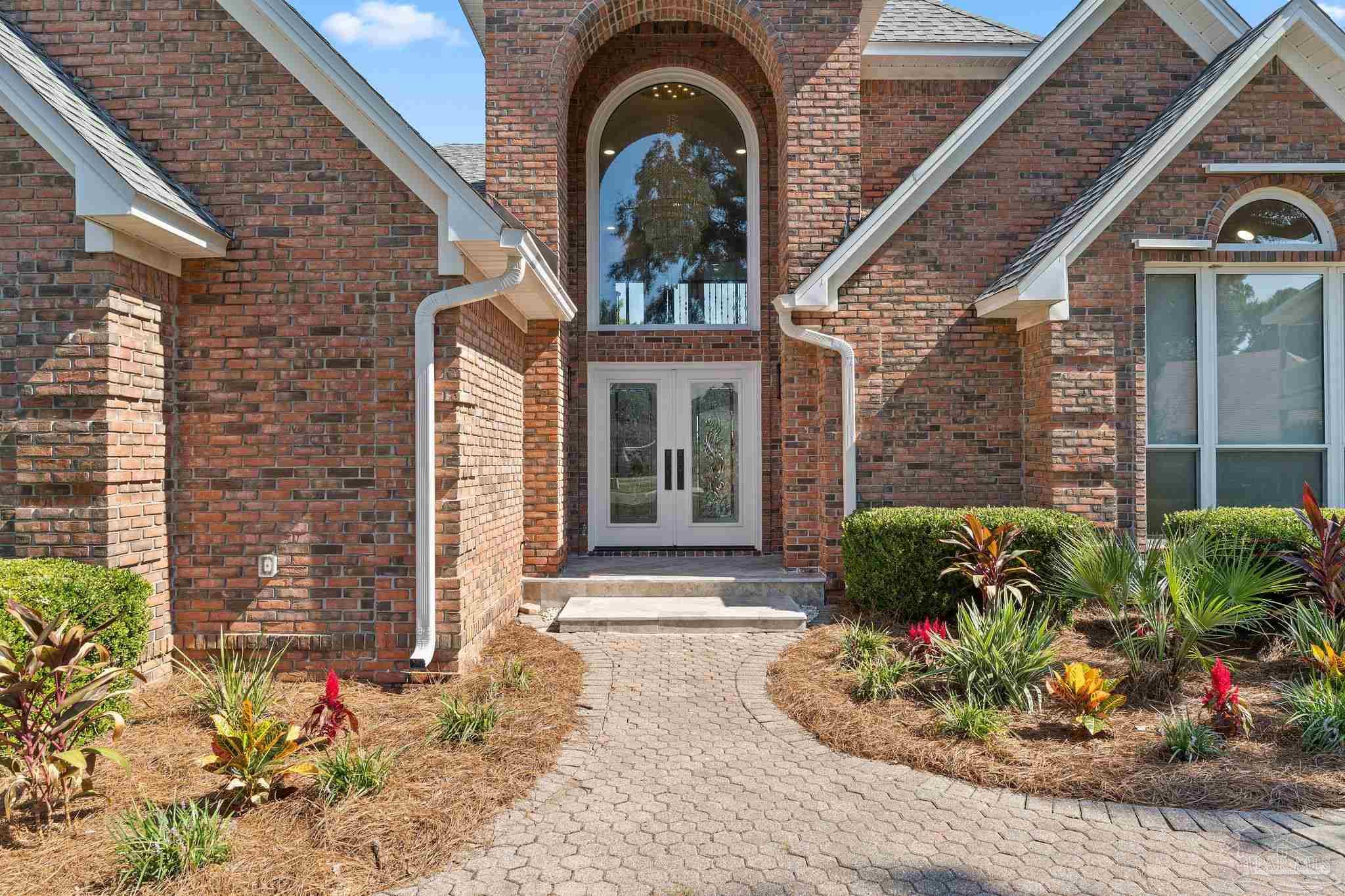 4818 Rosemont Place Pensacola, FL 32514 - Photo 6 of 69 a front view of a house with a garden