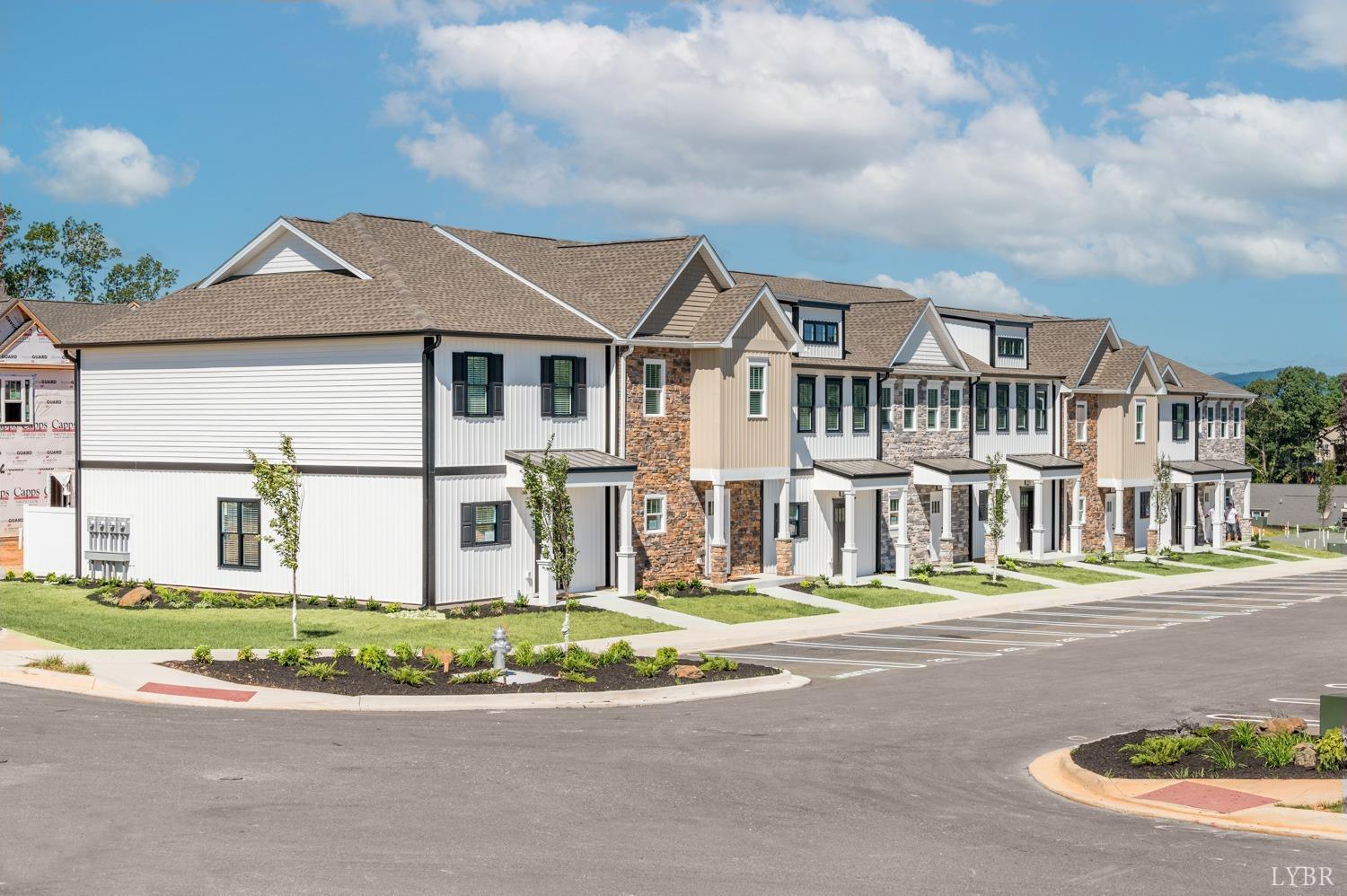 a front view of multiple houses with yard