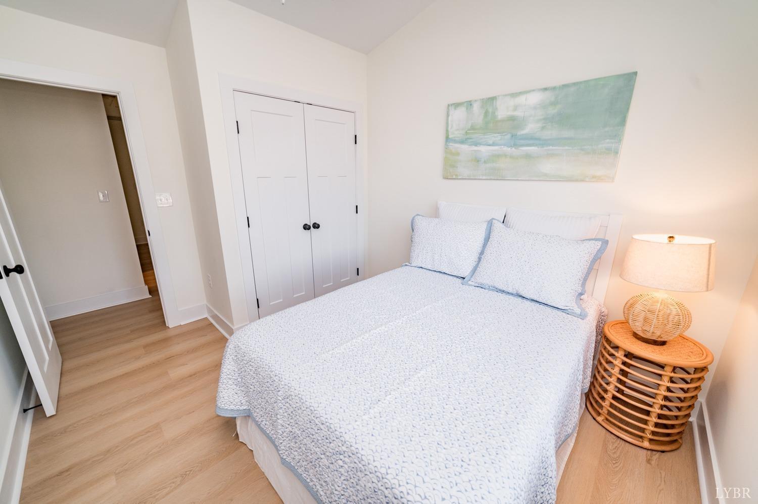 556 Leesville Road, Unit 208 Lynchburg, VA 24502 - Photo 35 of 40 a bedroom with a bed and wooden floor