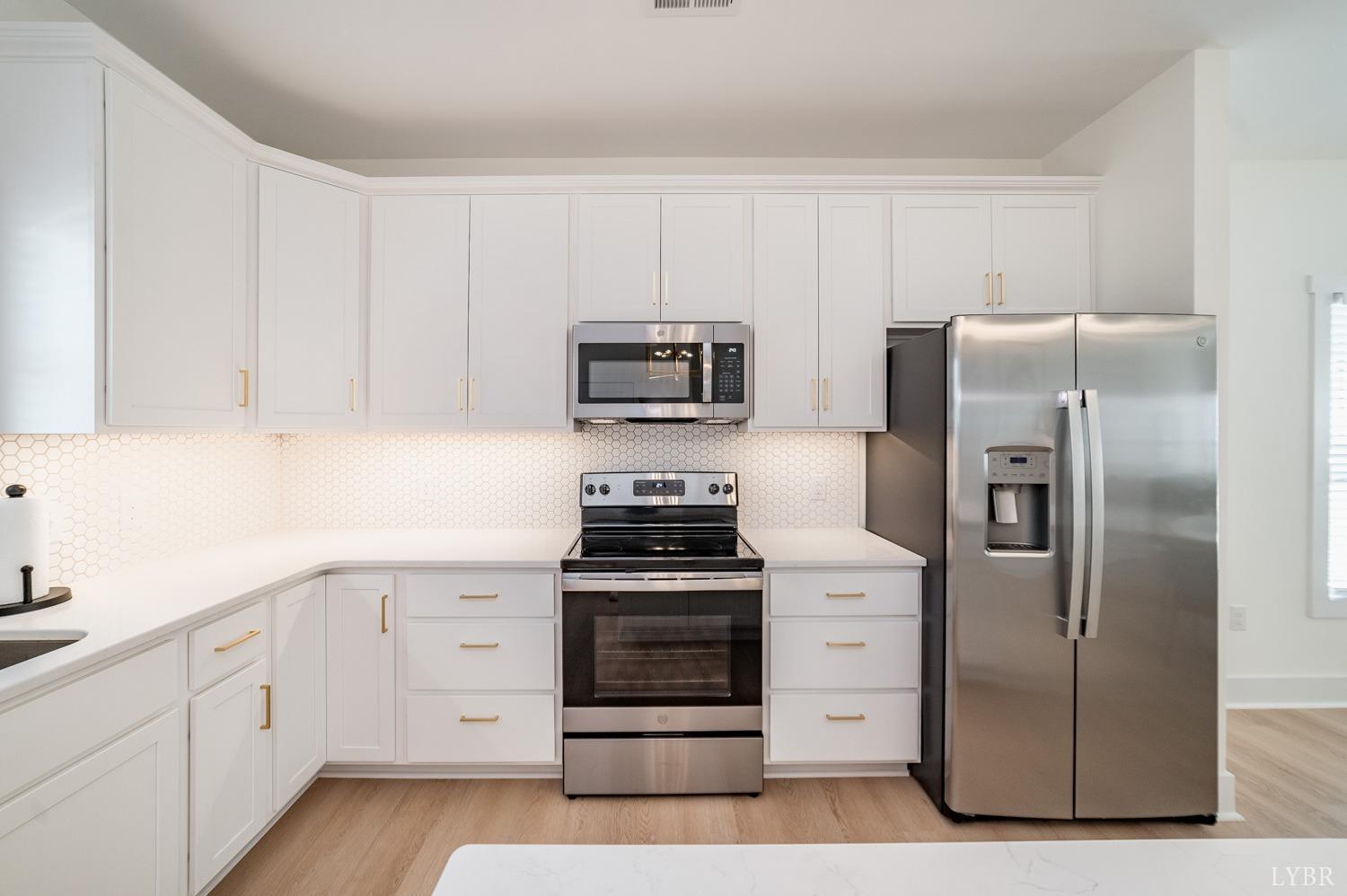556 Leesville Road, Unit 208 Lynchburg, VA 24502 - Photo 10 of 40 a kitchen with white cabinets and stainless steel appliances