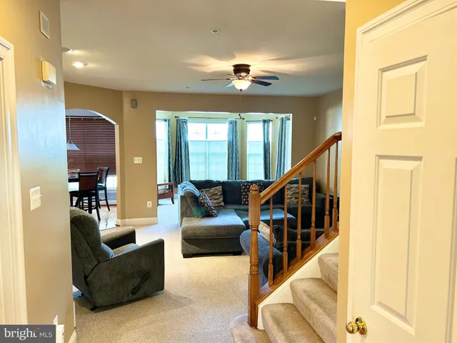 a living room with furniture and stairs