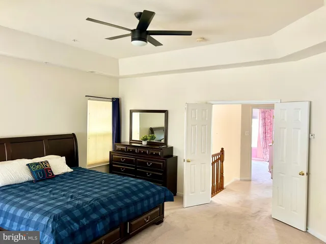 a bedroom with a bed and dresser with mirror