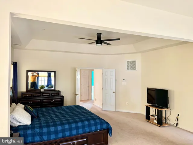 a bedroom with a bed and a television in it