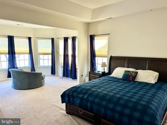 a bedroom with a large bed and a large window