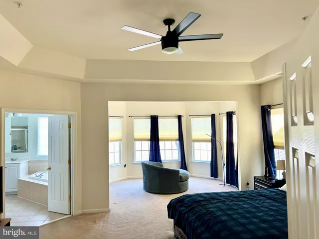 a bedroom with a large bed and a large window