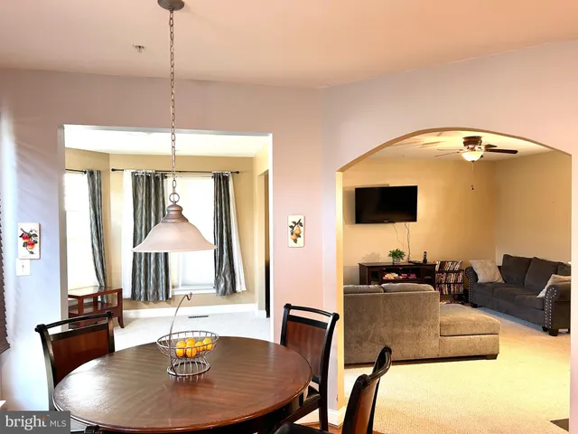 a dining room with furniture and window