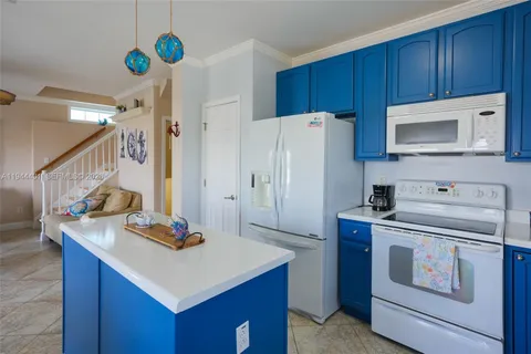 a kitchen with a stove a refrigerator and a sink
