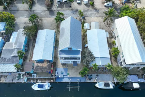 an aerial view of a house with patio swimming pool and outdoor seating