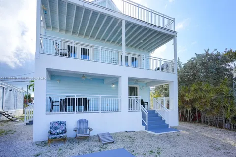 a front view of a house with outdoor seating