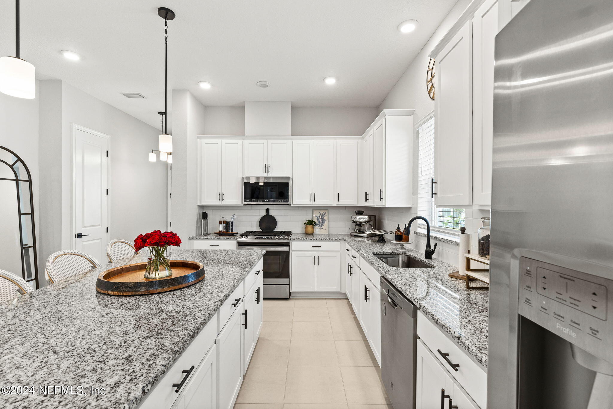 48 Bluebonnet Way St. Augustine, FL 32092 - Photo 11 of 47 a kitchen with kitchen island granite countertop a sink stainless steel appliances and cabinets