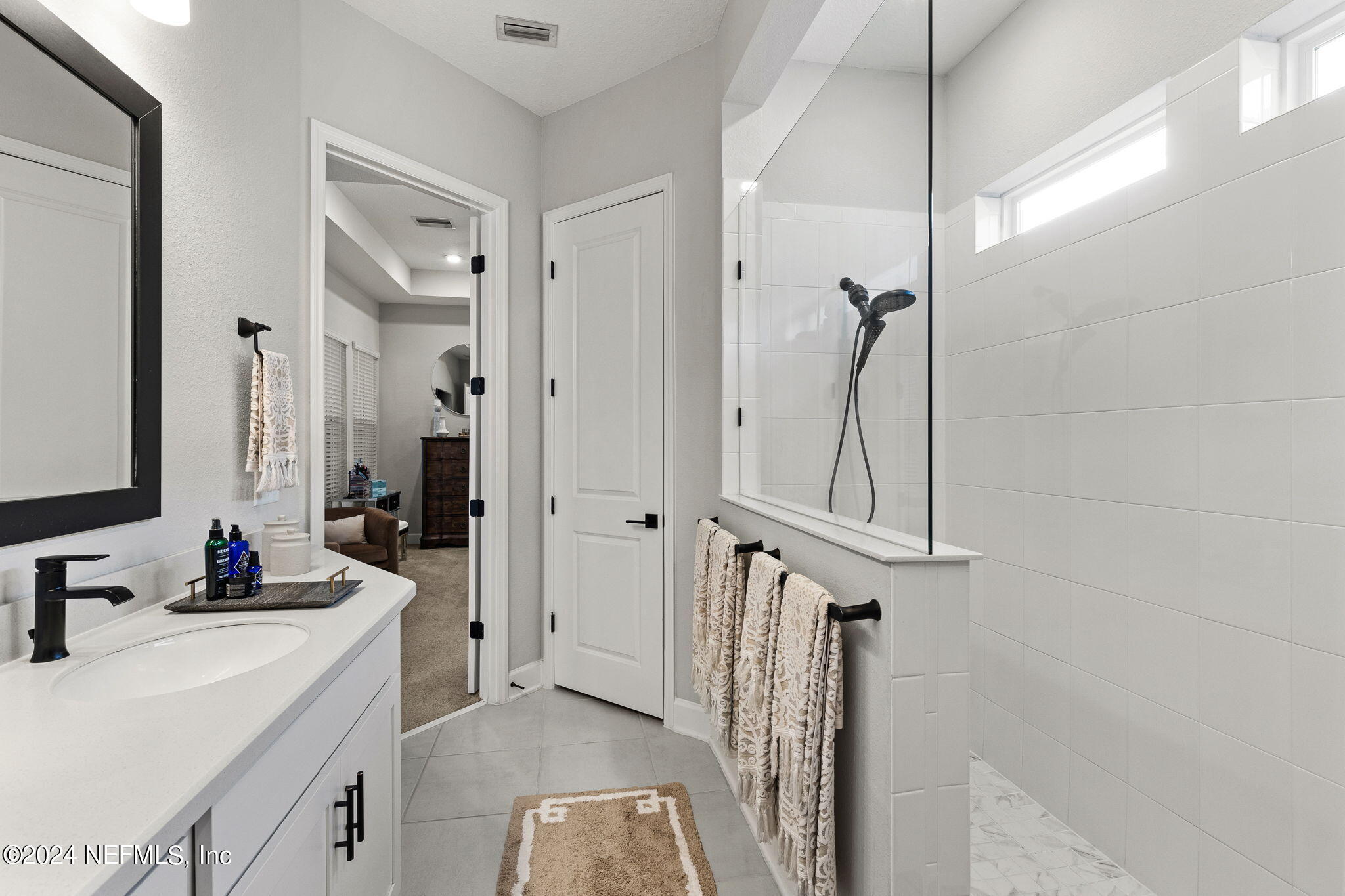 48 Bluebonnet Way St. Augustine, FL 32092 - Photo 16 of 47 a bathroom with a double vanity sink a mirror a vanity and a shower