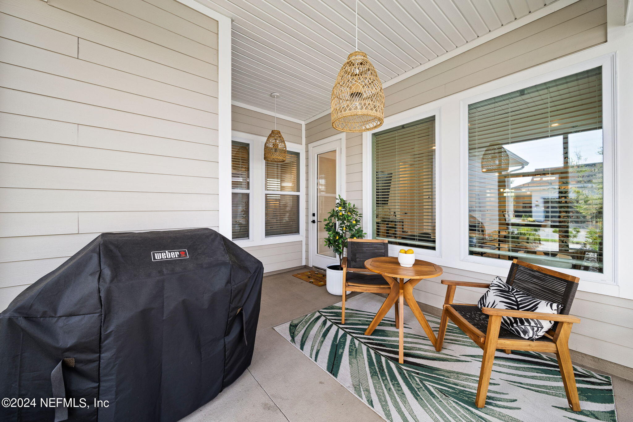 48 Bluebonnet Way St. Augustine, FL 32092 - Photo 26 of 47 a view of a patio with table and chairs and potted plants