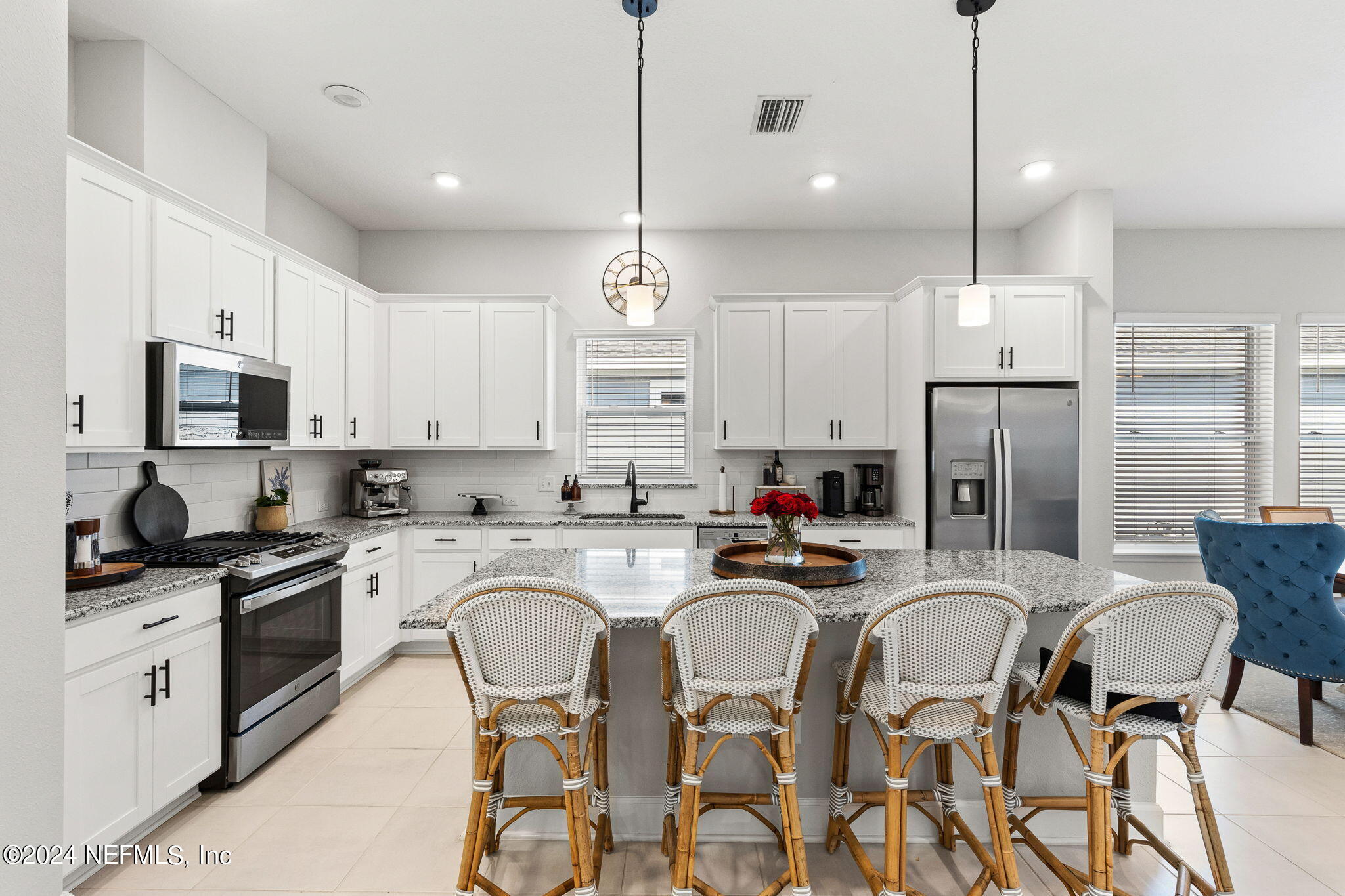 48 Bluebonnet Way St. Augustine, FL 32092 - Photo 9 of 47 a kitchen with stainless steel appliances granite countertop a stove a sink a stove a refrigerator cabinets and chairs