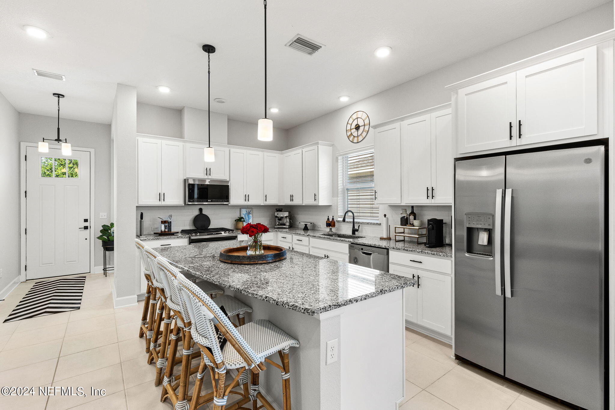 48 Bluebonnet Way St. Augustine, FL 32092 - Photo 10 of 47 a kitchen with stainless steel appliances granite countertop a sink a stove a refrigerator a center island and chairs