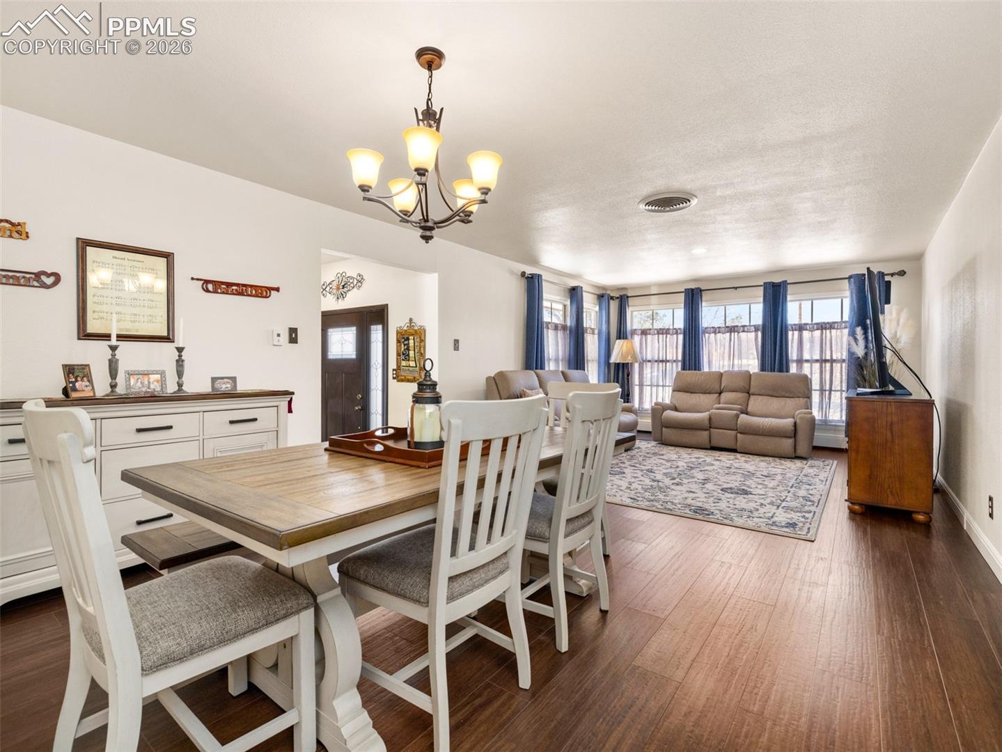 20 Robertson Road Pueblo, CO 81001 - Photo 12 of 39 Dining room with dark wood-style vinyl floors and a chandelier