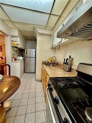 a kitchen with a stove and a refrigerator