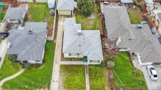 an aerial view of a house with a yard