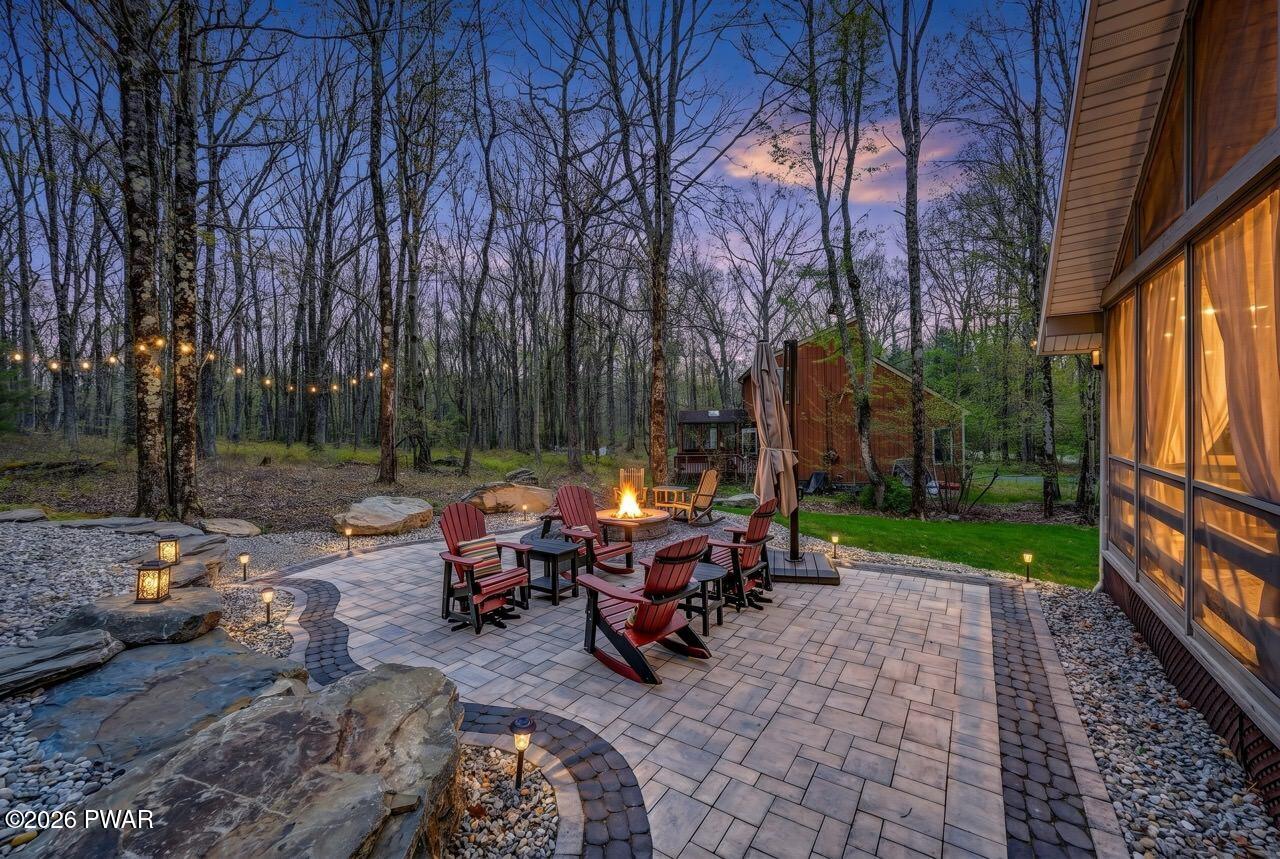 103 Forest Drive Hawley, PA 18428 - Photo 7 of 85 a view of a patio with table and chairs under an umbrella