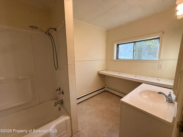 a bathroom with a tub and a shower