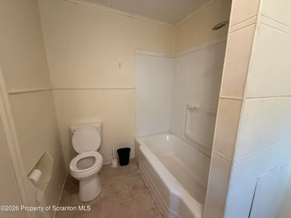 a white toilet sitting next to a sink