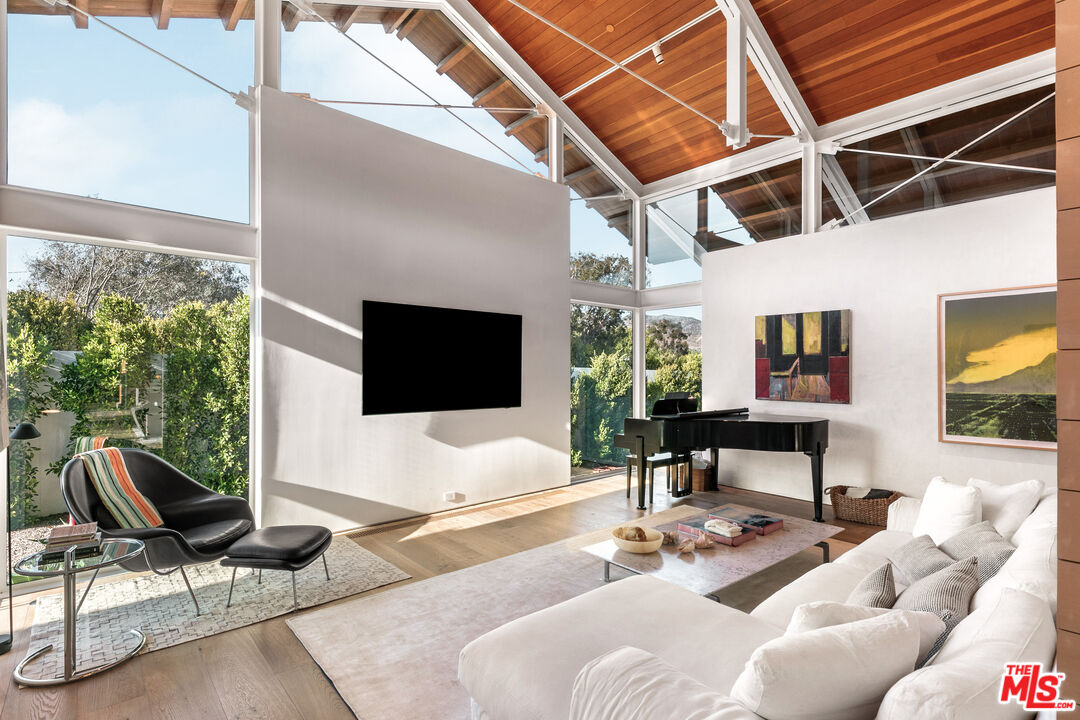 6728 Wildlife Road Malibu, CA 90265 - Photo 10 of 57 a living room with furniture and a flat screen tv