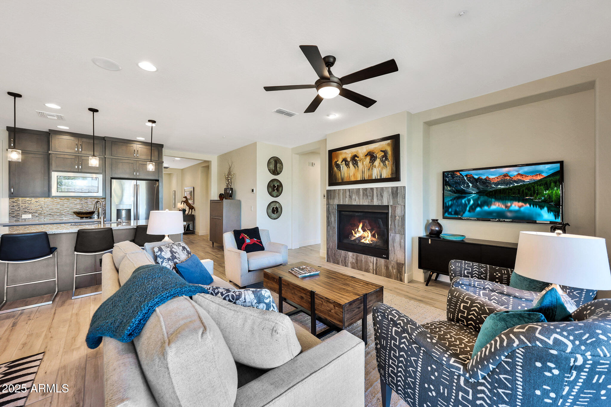 a living room with furniture a flat screen tv and a fireplace