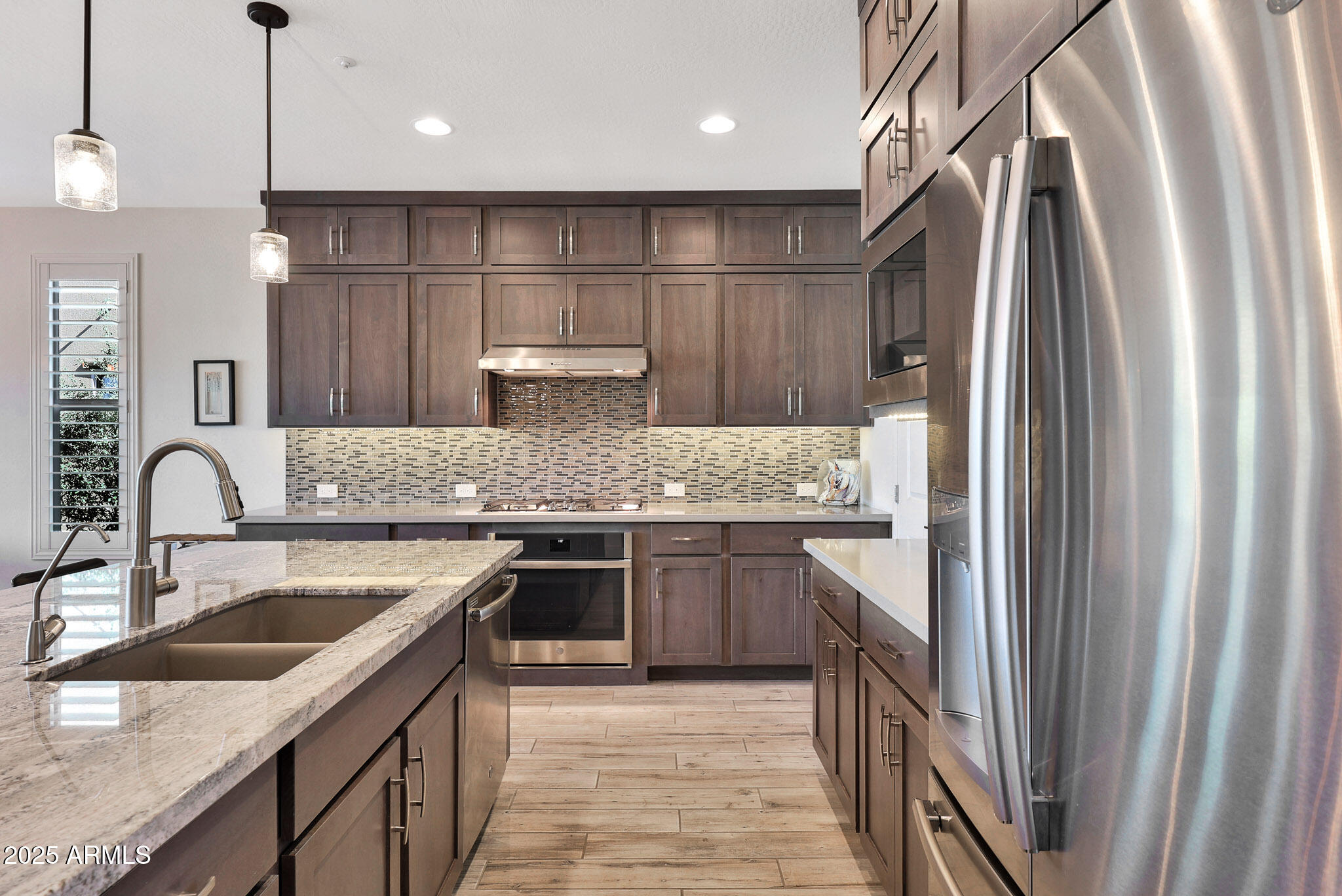 17940 East Cindercone Road Rio Verde, AZ 85263 - Photo 11 of 42 a kitchen with stainless steel appliances granite countertop a sink stove and refrigerator
